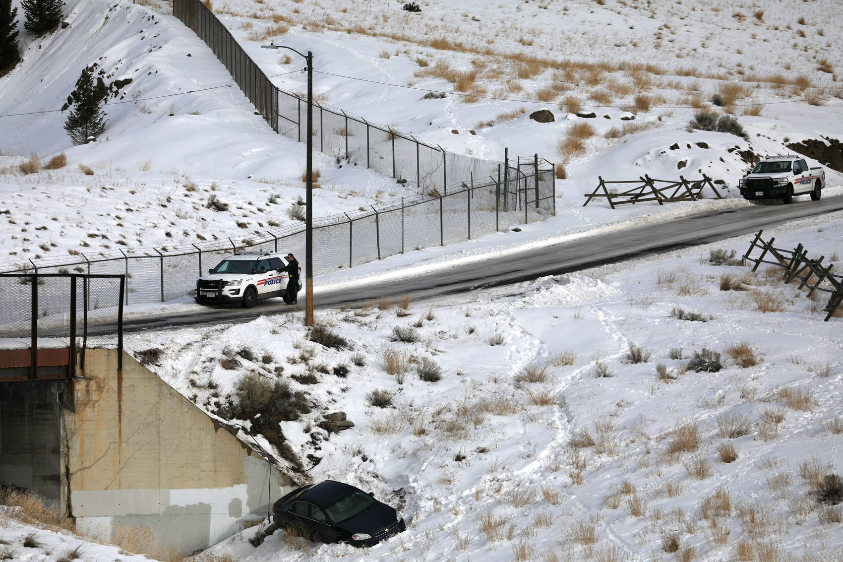 Car slips off icy street in Butte